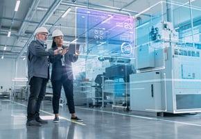 Two manufacturing professionals examine and analyze data on the job